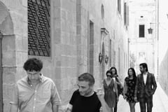 Paul Gordon from CARAVAN in conversation with Artistic Director Dr. Giuseppe Schembri Bonaci with the Mdina Biennale Action Group in the background